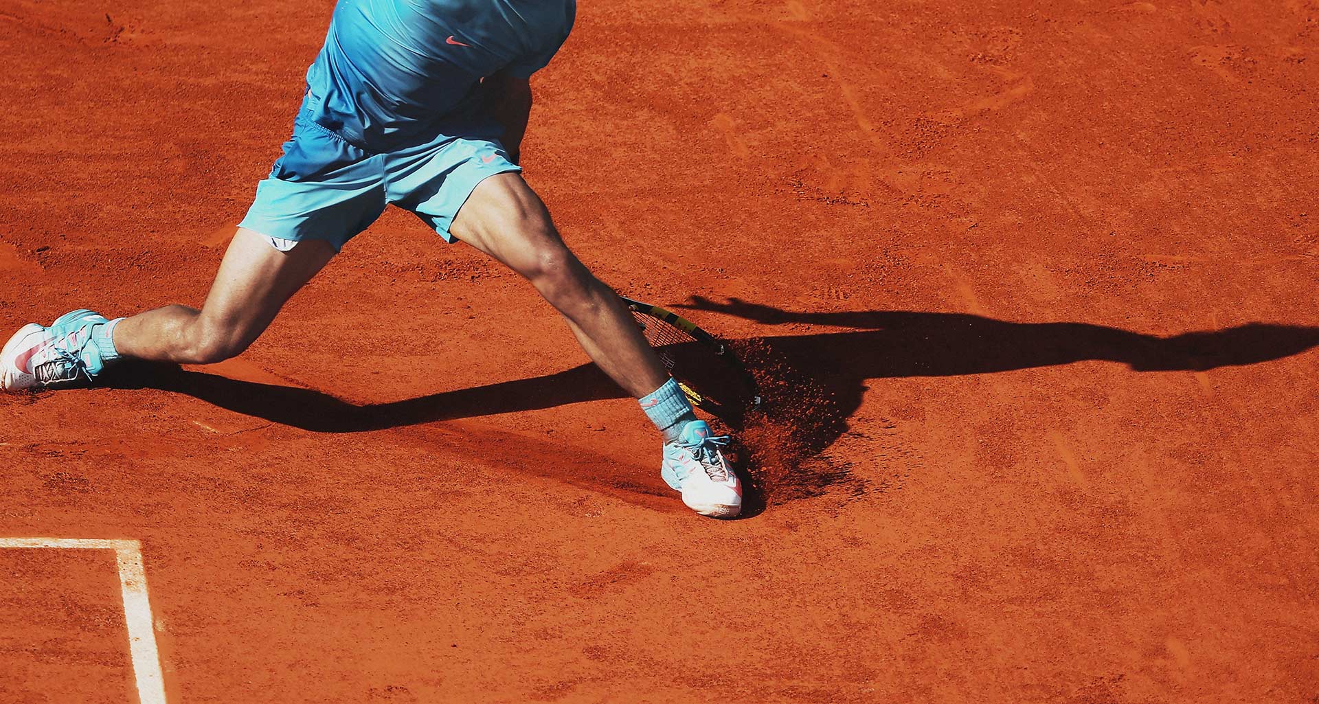 Tennis player on a red clay court